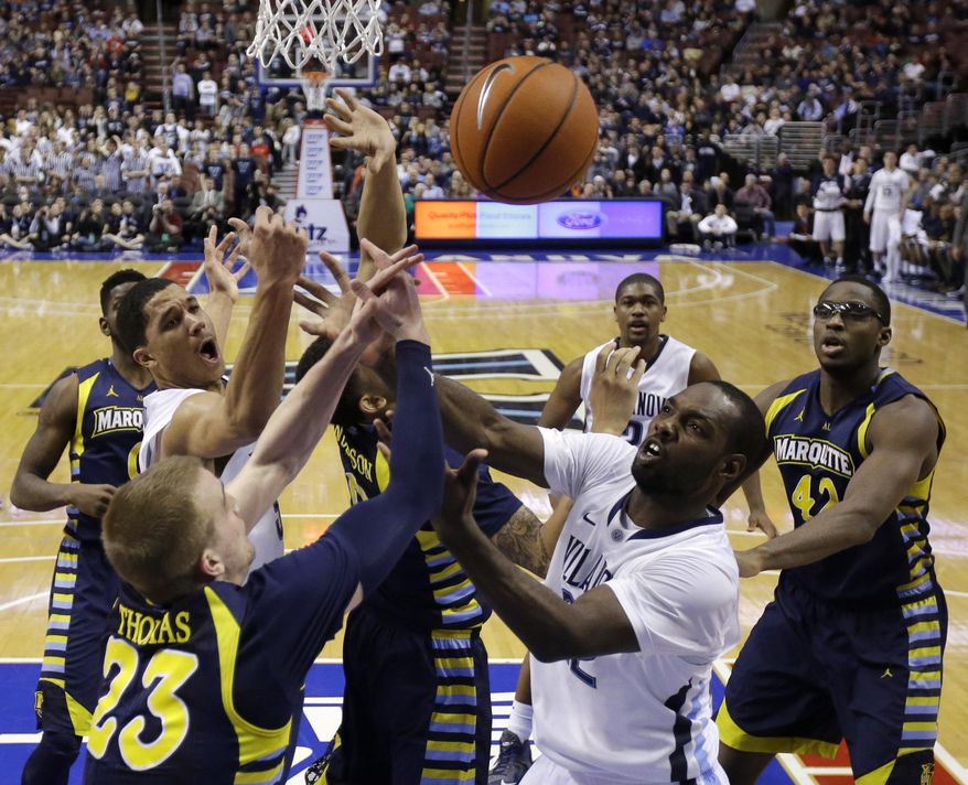 Marquette's Jake Thomas (23) and Villanova's JayVaughn Pinkston (22) battle for a rebound during the first half of an NCAA college basketball game on Sunday, March 2, 2014, in Philadelphia. (AP Photo/Matt Slocum)