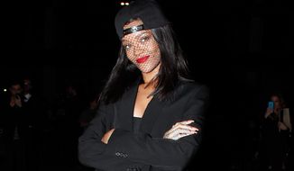 Singer Rihanna arrives at Givenchy&#39;s ready-to-wear fall/winter 2014-2015 fashion collection presented in Paris, Sunday, March 2, 2014. (AP Photo/Thibault Camus)