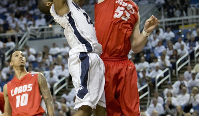 New Mexico&#x27;s Alex Kirk blocks the shot of Nevada&#x27;s Deonte Burton during the second half of an NCAA college basketball game Sunday, March 2, 2014, in Reno, Nev. (AP Photo/Reno Gazette-Journal, Tom R. Smedes) CARSON CITY OUT NO SALES
