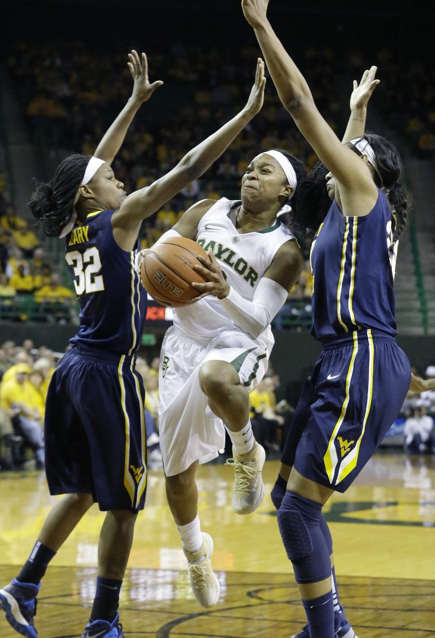 Baylor guard Odyssey Sims, center, drives between West Virginia forward Crystal Leary (32) and center Asya Bussie (20) during the first quarter of an NCAA college basketball game on Sunday, March 2, 2014, in Waco, Texas. (AP Photo/LM Otero)