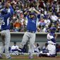 Kansas City Royals&#39; Mike Moustakas, center, is congratulated by teammate Eric Hosmer (35) after hitting a two-run home run during the fourth inning of a spring exhibition baseball game against the Chicago Cubs, Sunday, March 2, 2014, in Mesa, Ariz. (AP Photo/Morry Gash)