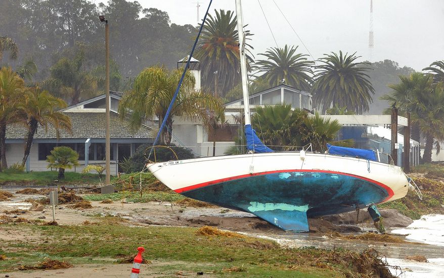 A sailboat washed ashore near a restaurant at Goleta, Calif., Saturday, March 1, 2014. The storm marked a sharp departure from many months of drought that has grown to crisis proportions for the state’s vast farming industry. However, such storms would have to become common to make serious inroads against the drought, weather forecasters have said. (AP Photo/Santa Barbara News-Press, Mike Eliason)