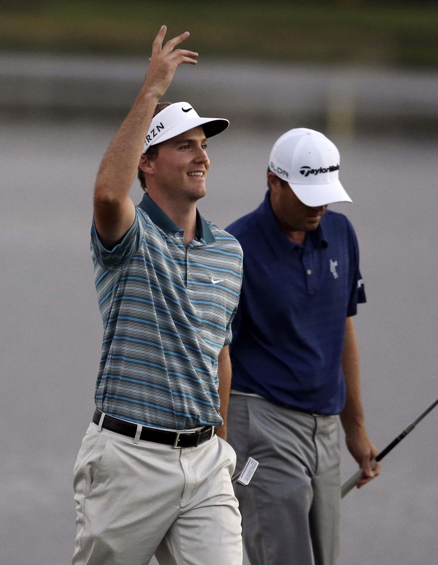 Russell Henley, left, reacts after hitting on the 18th hole during a four-way playoff in the final round of the Honda Classic golf tournament on Sunday, March 2, 2014, in Palm Beach Gardens, Fla. Henley went on to win with his last putt. (AP Photo/Lynne Sladky)