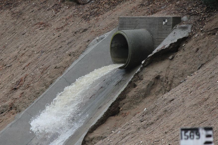 Runoff surges into a debris basin in Altadena, Calif., as thunderstorms dump rain on the San Gabriel Mountains on Saturday, March 1, 2014. Residents of some 1,200 homes in three foothill cities to the east were under evacuation orders due to danger of debris flows from steep slopes burned bare by recent wildfires.(AP Photo/ John Antczak)