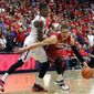 Stanford&#39;s Dwight Powell (33) tries to dribble around the defense of Arizona&#39;s Rondae Hollis-Jefferson during the first half of an NCAA college basketball game  Sunday, March 2, 2014, in Tucson, Ariz. (AP Photo/John MIller)