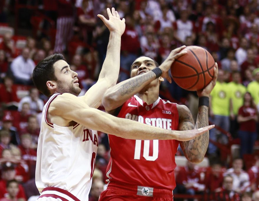 Indiana forward Will Sheehey, left, fouls Ohio State forward LaQuinton Ross as Ross goes to the basket in the first half of an NCAA basketball game in Bloomington, Ind. Sunday, March 2, 2014. (AP Photo/R Brent Smith)