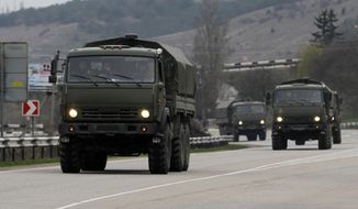 A Russian convoy moves from Sevastopol to Sinferopol in the Crimea, Ukraine, Sunday, March 2, 2014. A convoy of hundreds of Russian troops headed toward the regional capital of Ukraine&#x27;s Crimea region on Sunday, a day after Russia&#x27;s forces took over the strategic Black Sea peninsula without firing a shot. The new government in Kiev has been powerless to react. Ukraine&#x27;s parliament was meeting Sunday in a closed session. (AP Photo/Darko Vojinovic)