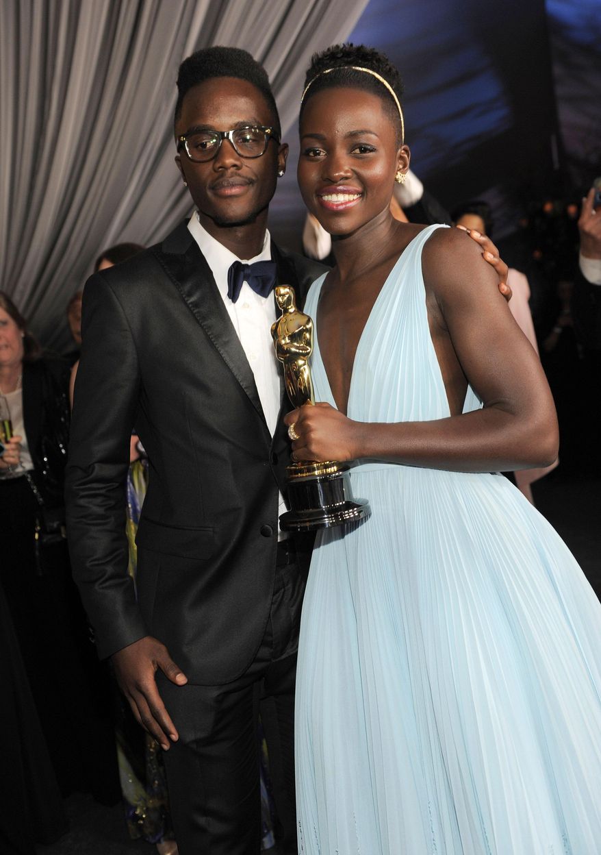 Lupita Nyong'o, winner of the award for best actress in a supporting role for "12 Years a Slave", right, and her brother Peter attend the Governors Ball after the Oscars on Sunday, March 2, 2014, at the Dolby Theatre in Los Angeles. (Photo by Chris Pizzello/Invision/AP)
