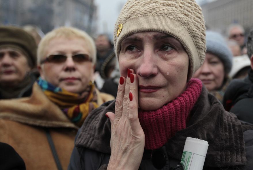 A woman reacts, during a rally in Kiev's Independence Square, Sunday, March 2, 2014. Ukraine's new prime minister urged Russian President Vladimir Putin to pull back his military Sunday in the conflict between the two countries, warning that "we are on the brink of disaster." The comments from Arseniy Yatsenyuk came as a convoy of Russian troops rolled toward Simferopol, the capital of Ukraine's Crimea region, a day after Russian forces took over the strategic Black Sea peninsula without firing a shot. (AP Photo/Sergei Chuzavkov)