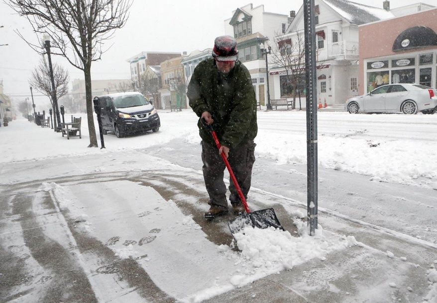 Walt Hohman, shovels the front of his business, Wards Pastry, along Asbury Avenue, in Ocean City, NJ, during a snowstorm Monday, March 3, 3014. Winter kept its icy hold on much of the country Monday, with snow falling and temperatures dropping as schools and offices closed and people from the South and Mid-Atlantic to Northeast reluctantly waited out another storm indoors. (AP Photo/The Press of Atlantic City, Vernon Ogrodnek) MANDATORY CREDIT