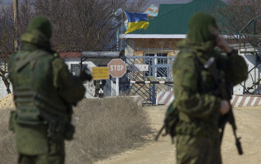 Pro-Russian soldiers block the Ukrainian naval base in the village of Novoozerne, some 91 km west of Crimean capital Simferopol, Ukraine, on Monday, March 3, 2014. Ukraine says Russian forces controlling the strategic region of Crimea are demanding that the crew of two Ukrainian warships in Sevastopol's harbor must surrender. (AP Photo/Ivan Sekretarev)