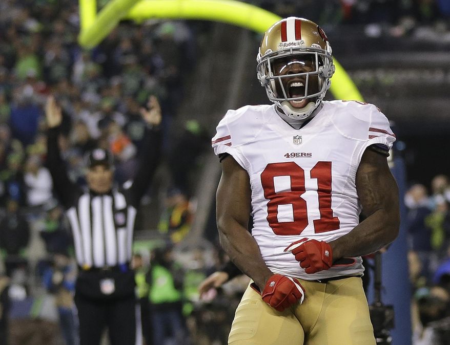 FILE - In this Jan. 19, 2014 file photo, San Francisco 49ers' Anquan Boldin celebrates his touchdown catch during the second half of the NFL football NFC Championship game against the Seattle Seahawks, in Seattle. Boldin says he will be back with the San Francisco 49ers next season. Boldin wrote on his Twitter page Monday, March 3, 2014, that he's "returning to San Francisco. A spokesman for the 49ers said the team had no immediate comment. (AP Photo/Marcio Jose Sanchez, File)
