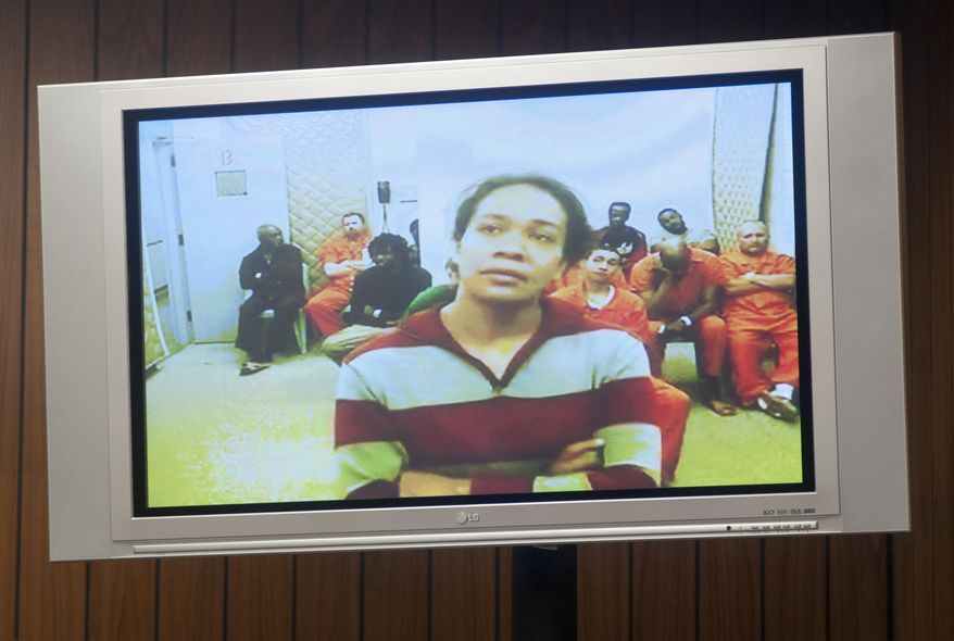 Mio Campbell, 30, appears via video for her arraignment in front of Saginaw County District Judge Kyle Higgs Tarrant, Monday, March 3, 2014. Campbell and Aki C. Dillard, 39, are charged in connection with the injuries police say their 6-year-old son suffered Thursday, Feb. 27. The boy died over the weekend, and prosecutors are awaiting on an autopsy report before amending any charges. (AP Photo/The Saginaw News, Jeff Schrier)