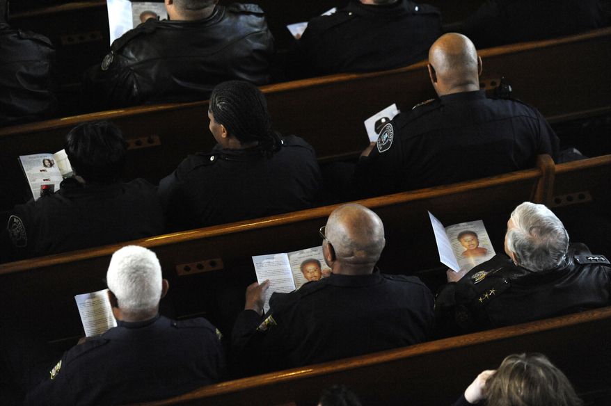 Detroit police attend the funeral of Jayvon Felton at Hartford Memorial Baptist Church in Detroit on Monday, March 3, 2014 in Detroit.  Chief James Craig spoke during the family hour ahead of the service and said the department wanted to treat Jayvon’s funeral as if the boy was an officer. Jayvon was in an open casket and wore a police badge.  Jayvon was diagnosed in April with leukemia. He died Feb. 24 at a Detroit hospital. The fourth-grader had always wanted to be a Detroit police officer. (AP Photo/Detroit News, David Coates)  DETROIT FREE PRESS OUT; HUFFINGTON POST OUT