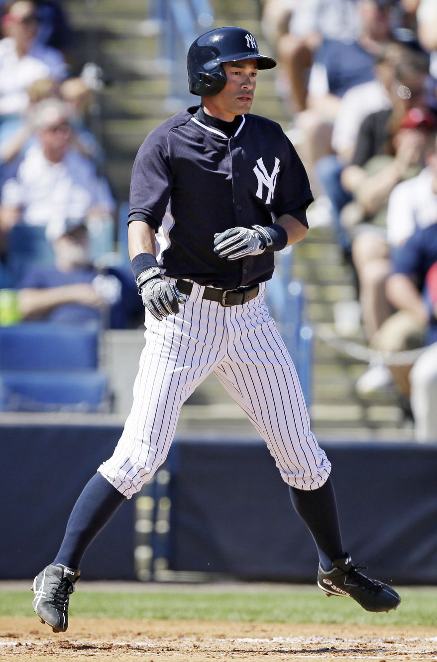 New York Yankees right fielder Ichiro Suzuki reacts after scoring a run in the second inning of an exhibition baseball game against the Washington Nationals, Monday, March 3, 2014, in Tampa, Fla. (AP Photo/Charlie Neibergall)