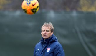 Juergen Klinsmann, coach of the US American national soccer team, leads a training session of his team   in Frankfurt Germany,  Monday March 3, 2014. The USA will face Ukraine on Cyprus on Wednesday.   (AP Photo/dpa,Boris Roessler)