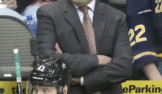 Dallas Stars head coach Lindy Ruff yells from the bench behind right wing Valeri Nichushkin (43) during the third period of an NHL hockey game against the Buffalo Sabres Monday, March 3, 2014, in Dallas. The Stars won 3-2. (AP Photo/LM Otero)