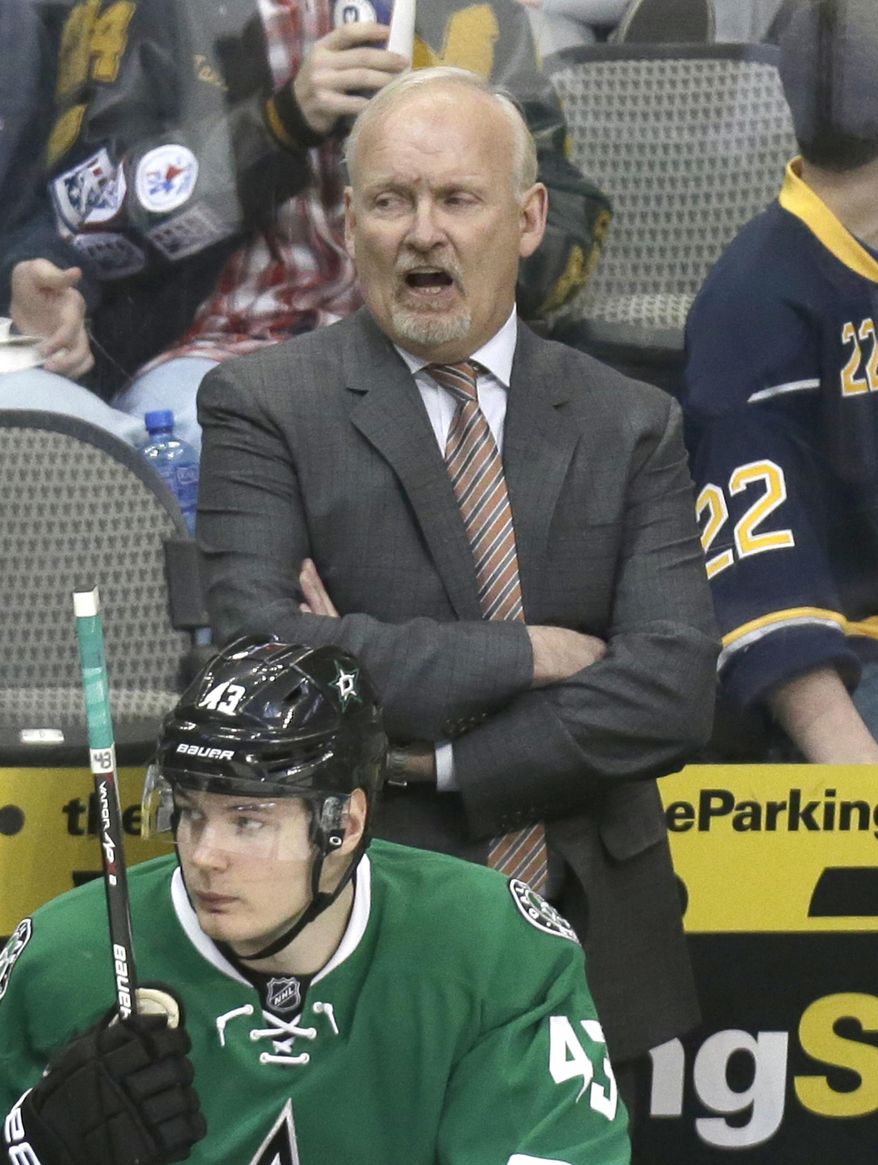 Dallas Stars head coach Lindy Ruff yells from the bench behind right wing Valeri Nichushkin (43) during the third period of an NHL hockey game against the Buffalo Sabres Monday, March 3, 2014, in Dallas. The Stars won 3-2. (AP Photo/LM Otero)