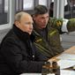 Russian President Vladimir Putin, listens to Gen. Ivan Buvaltsev, right, as they observe a military exercise near St. Petersburg, Russia, Monday, March 3, 2014.  pro-Russian troops held all Ukrainian border posts Monday in Crimea, as well as all military facilities and a key ferry terminal, cementing their stranglehold on the strategic Ukrainian peninsula. (AP Photo/RIA-Novosti, Mikhail Klimentyev, Presidential Press Service)