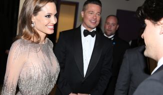 Angelina Jolie, left, and Brad Pitt appear at the Oscars on Sunday, March 2, 2014, at the Dolby Theatre in Los Angeles.  (Photo by Matt Sayles/Invision/AP)