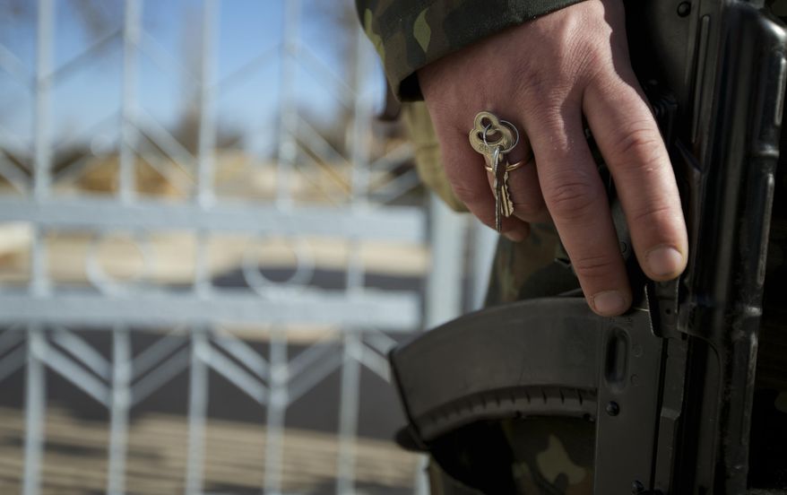 Keys are hooked in a ring of a Ukrainian soldier guarding the naval base headquarters in the town of Novo-Ozerne, some 90 km west of the Crimean capital Simferopol, Ukraine, on Monday March 3, 2014. For years, the little Crimean town was closed off from the rest of the world, a secretive community, at the edge of a key Soviet naval base, sealed by roadblocks and armed guards. There’s not much in town anymore. But the Russians want it. And the little forgotten town is now sharply divided, torn between those who welcomed the arrival here over the weekend of dozens of Russian soldiers wearing unmarked uniforms, and those who back the Ukrainians who are refusing to surrender their weapons. (AP Photo/Ivan Sekretarev)