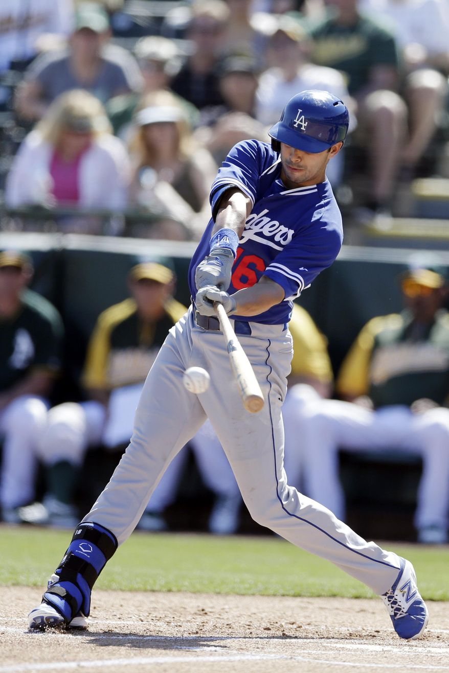 Los Angeles Dodgers' Andre Ethier hits a single while batting against the Oakland Athletics during the first inning of a spring training baseball game Monday, March 3, 2014, in Phoenix. (AP Photo/Gregory Bull)