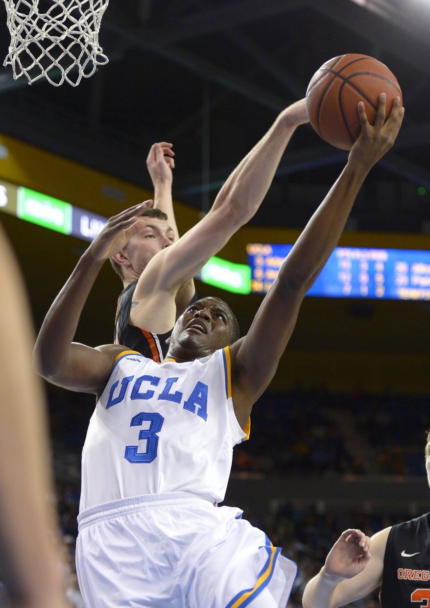 UCLA guard Jordan Adams, right, puts up a shot as Oregon State center Angus Brandt defends during the second half of an NCAA college basketball game, Sunday, March 2, 2014, in Los Angeles. UCLA won 74-69. (AP Photo/Mark J. Terrill)