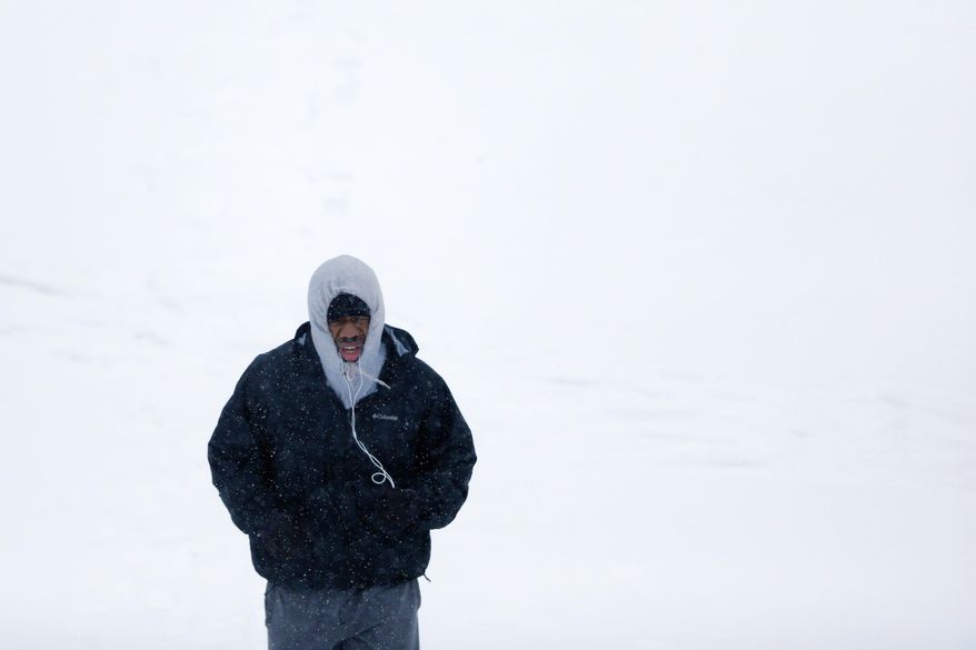 A man exercises during a winter snowstorm Monday, March 3, 2014, in Philadelphia. (AP Photo/Matt Rourke)