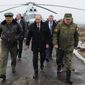 Russian President Vladimir Putin, center, and Defense Minister Sergei Shoigu, left, and the commander of the Western Military District Anatoly Sidorov, right, walk upon arrival to watch military exercise near St.Petersburg, Russia, Monday, March 3, 2014. Putin has sought and quickly got the Russian parliament&#39;s permission to use the Russian military in Ukraine.(AP Photo/RIA-Novosti, Mikhail Klimentyev, Presidential Press Service)