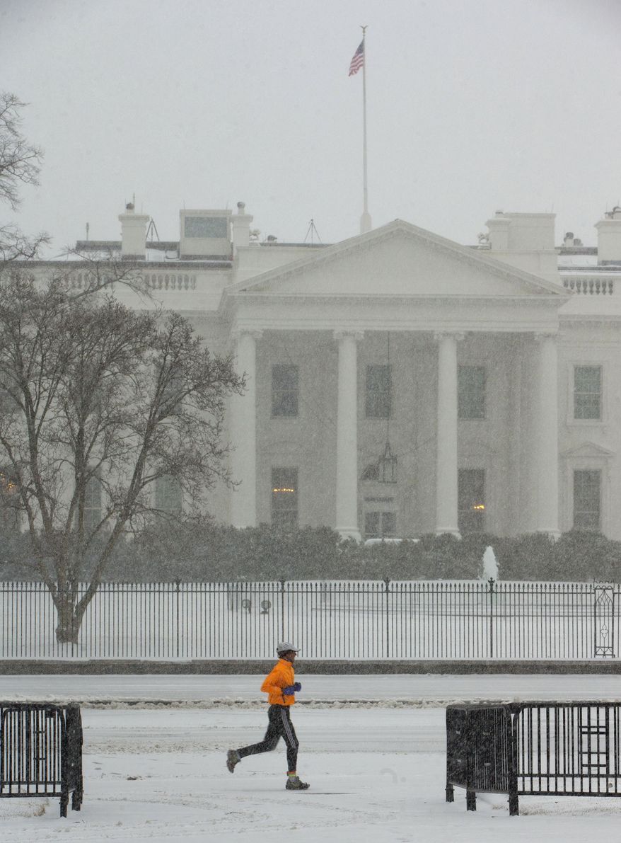 A jogger is seen in Lafayette Park in the snow front of the White House in Washington, Monday, March 3, 2014. The National Weather Service has issued a Winter Storm Warning for the greater Washington Metropolitan region, prompting area schools and the federal government to close for the wintry weather. (AP Photo/Pablo Martinez Monsivais)