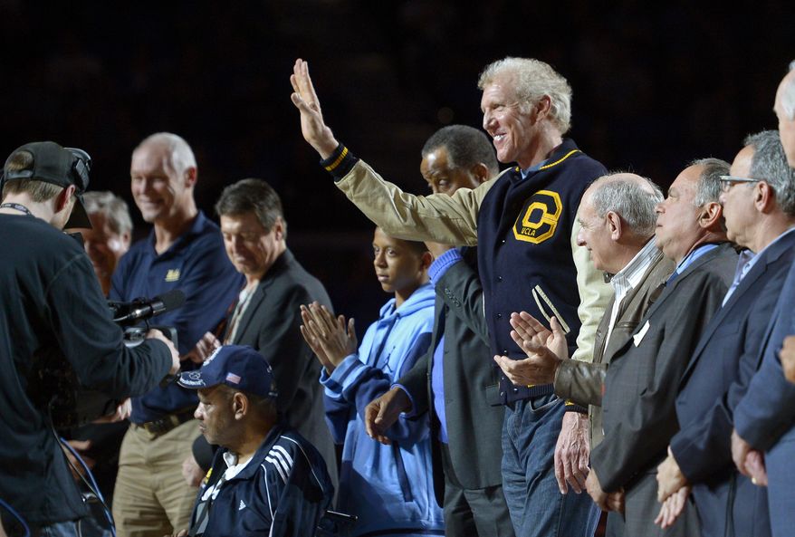 Former UCLA center Bill Walton waves as he stands with surviving members of the 1972-1973 NCAA championship team during a ceremony to honor them during halftime of and NCAA college basketball game between UCLA and Oregon State, Sunday, March 2, 2014, in Los Angeles. UCLA won 74-69. (AP Photo/Mark J. Terrill)