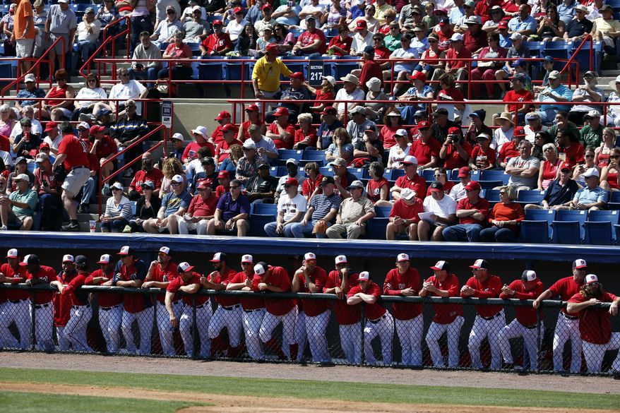 Members of the Washington Nationals line the rail in a spring exhibition baseball game against the Atlanta Braves, Saturday, March 1, 2014, in Viera, Fla. (AP Photo/Alex Brandon)