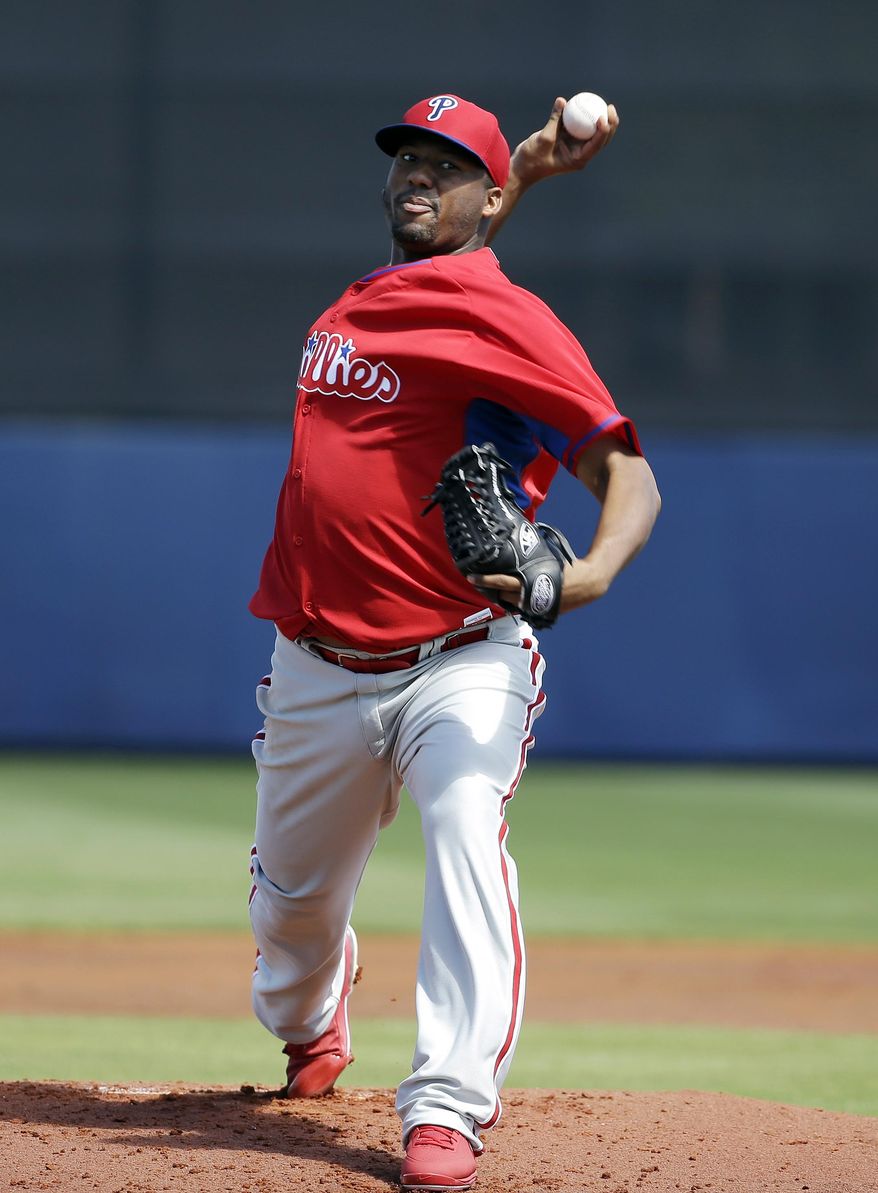 Philadelphia Phillies pitcher Roberto Hernandez delivers a warm-up throw in the first inning an exhibition baseball game against the Tampa Bay Rays, Monday, March 3, 2014, in Port Charlotte, Fla. (AP Photo/Steven Senne)