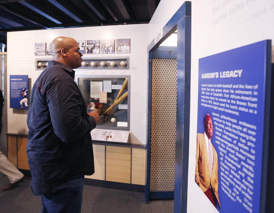 Former Chicago White Sox player Frank Thomas visits a Hank Aaron exhibit during his orientation visit at the Baseball Hall of Fame on Monday, March 3, 2014, in Cooperstown, N.Y. Thomas will be inducted to the hall in July. (AP Photo/Mike Groll)