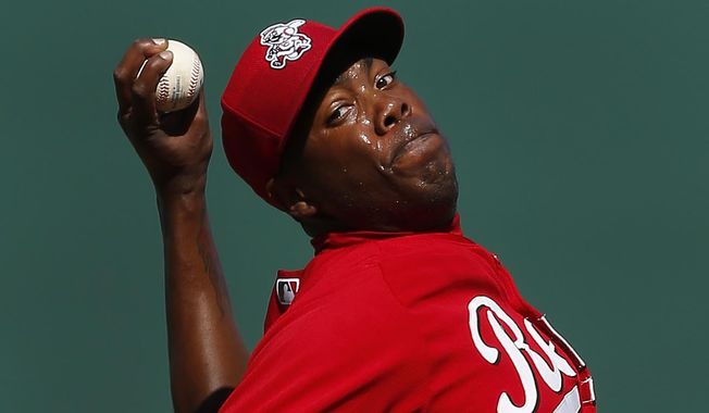 Cincinnati Reds pitcher Aroldis Chapman throws against the Seattle Mariners during an exhibition baseball game in Goodyear, Ariz., Monday, March 3, 2014. (AP Photo/Paul Sancya)