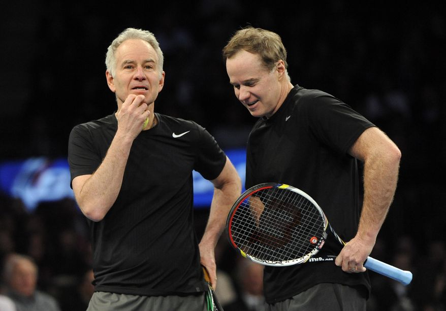 John, left, and Patrick McEnroe confer during their match against Mike and Bob Bryan in the BNP Paribas Showdown Tennis Tournament on Monday, March 3, 2014, in New York. The Bryans won 8-3. (AP Photo/Kathy Kmonicek)