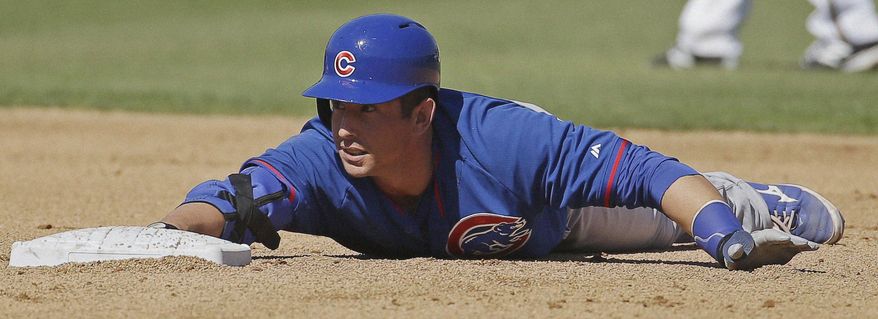 Chicago Cubs' John Baker slides into second for a double during the fourth inning of an exhibition spring training baseball game against the Milwaukee Brewers Monday, March 3, 2014, in Phoenix. (AP Photo/Morry Gash)