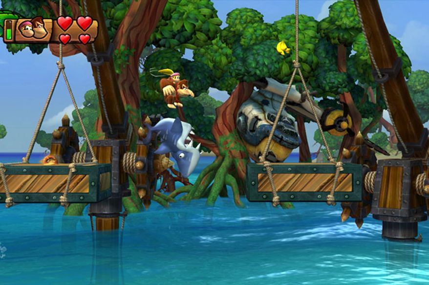 Donkey and Dixie Kong play with sharks in the video game Donkey Kong Country: Tropical Freeze for the Nintendo Wii U.