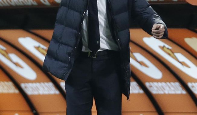 Juventus coach Antonio Conte points to his players during a Serie A soccer match between AC Milan and Juventus, at the San Siro stadium in Milan, Italy, Sunday, March 2, 2014. (AP Photo/Luca Bruno)