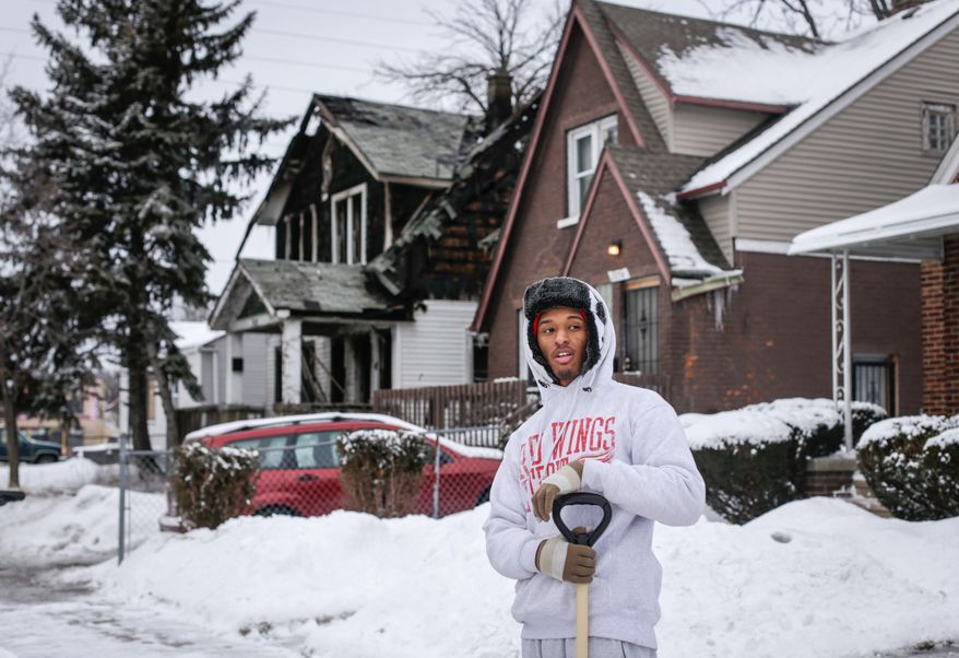 Armani Samuel, 19, talks about the close ties of the community despite the abandoned houses on his block after an arsonist set a house, and several others, ablaze on Sunday, March 2, 2014 in Detroit. Authorities say an arson suspect has been arrested shortly after fires broke out on four different Detroit streets. Lt. Dennis Richardson, a Detroit arson investigator say that fires were set in four vacant homes starting around 11:15 a.m. Sunday. Two of the fires spread to adjacent homes and one occupied home was destroyed. Richardson says no one was injured. (AP Photo/Detroit Free Press, Jarrad Henderson)