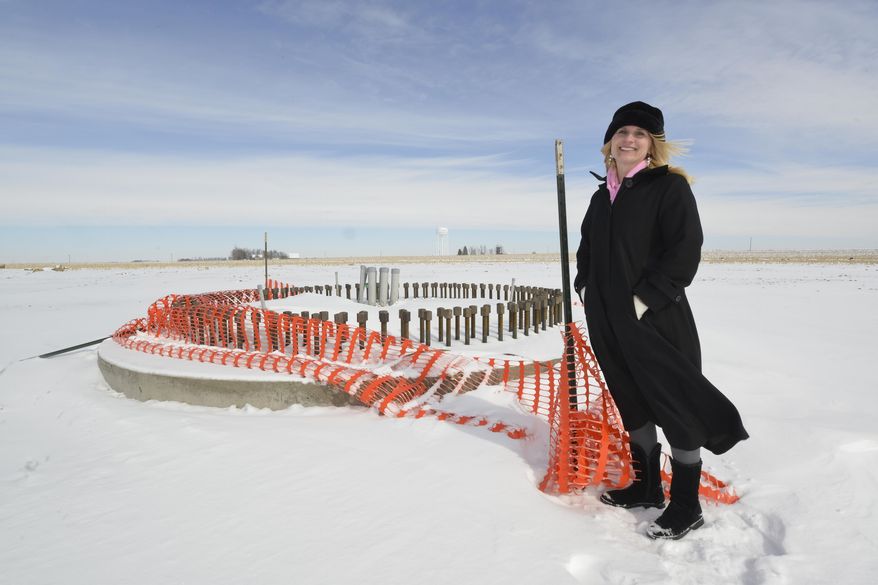 Kiana Johnson, O'Brien County economic development director, stands Tuesday, Feb. 25, 2014, at the base of what will become a wind turbine in Highland Township southeast of Primghar, Iowa. (AP Photo/Sioux City Journal, Tim Hynds)