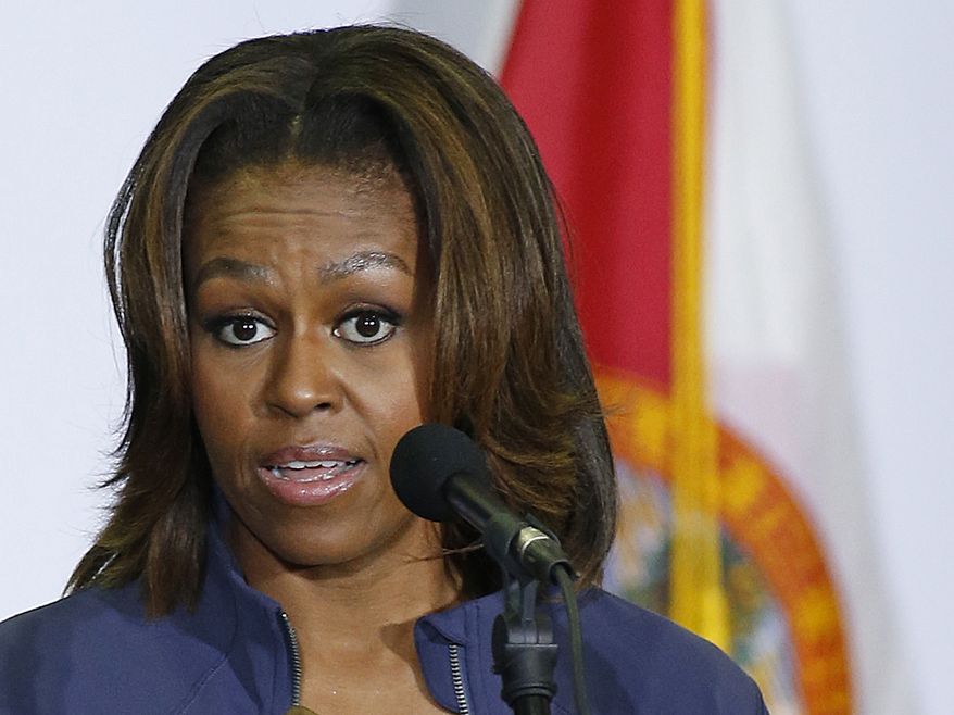 FILE - In this Feb. 25, 2014 file-pool photoFirst lady Michelle Obama speaks in Miami. Michelle Obama plans a weeklong solo visit to China this month that includes meetings with China’s first lady and high school and university students. It will be her first visit ever to the Asian economic powerhouse. In an announcement Monday on the White House blog, the first lady says a China visit is important because it is the most populous country in the world, with more than 1.3 billion people, and plays an important role on the world stage. (AP Photo/Joel Auerbach, File)
