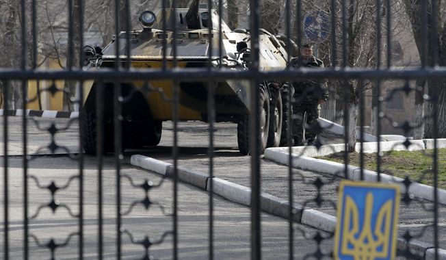 A Ukrainian armored personnel carrier is stationed behind the gate of a military base in the port of Kerch, Ukraine, Monday, March 3, 2014. Pro-Russian troops controlled a ferry terminal on the easternmost tip of Ukraine&#x27;s Crimea region close to Russia on Monday, intensifying fears that Moscow will send even more troops into the strategic Black Sea region in its tense dispute with its Slavic neighbor. (AP Photo/Darko Vojinovic)