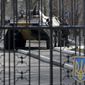 A Ukrainian armored personnel carrier is stationed behind the gate of a military base in the port of Kerch, Ukraine, Monday, March 3, 2014. Pro-Russian troops controlled a ferry terminal on the easternmost tip of Ukraine&#x27;s Crimea region close to Russia on Monday, intensifying fears that Moscow will send even more troops into the strategic Black Sea region in its tense dispute with its Slavic neighbor. (AP Photo/Darko Vojinovic)