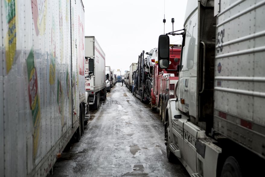 Trucks were at a standstill along Petro Road as truckers and commuters escaped standstill traffic along Interstate 40 and Interstate 55 after a combination of ice and wrecks Tuesday, March 4, 2014, in West Memphis, Ark. Some motorists on the highway in eastern Arkansas were stranded overnight due to lingering icy conditions from a weekend winter storm. An Arkansas highway department spokesman said Tuesday that traffic can't get moving consistently because of repeated accidents.(AP Photo/The Commercial Appeal, Brad Vest)