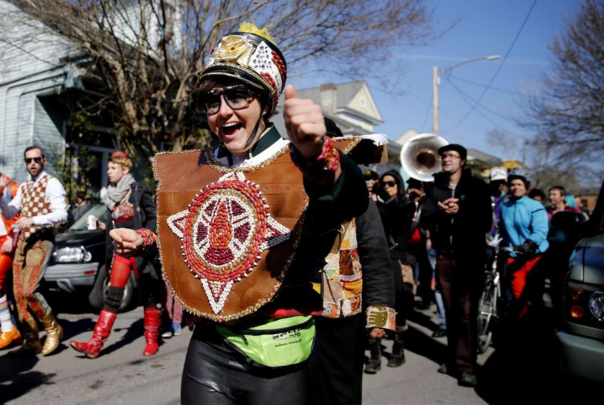The sixth annual Red Beans Parade rolled through the Marigny and ended in the Treme with The Treme Brass Band on Lundi Gras, Monday, March 3, 2014, in New Orleans. Participants sported costumes made of various kinds of beans. (AP Photo/NOLA.com The Times-Picayune, Kathleen Flynn) MAGS OUT; NO SALES; USA TODAY OUT; THE BATON ROUGE ADVOCATE OUT