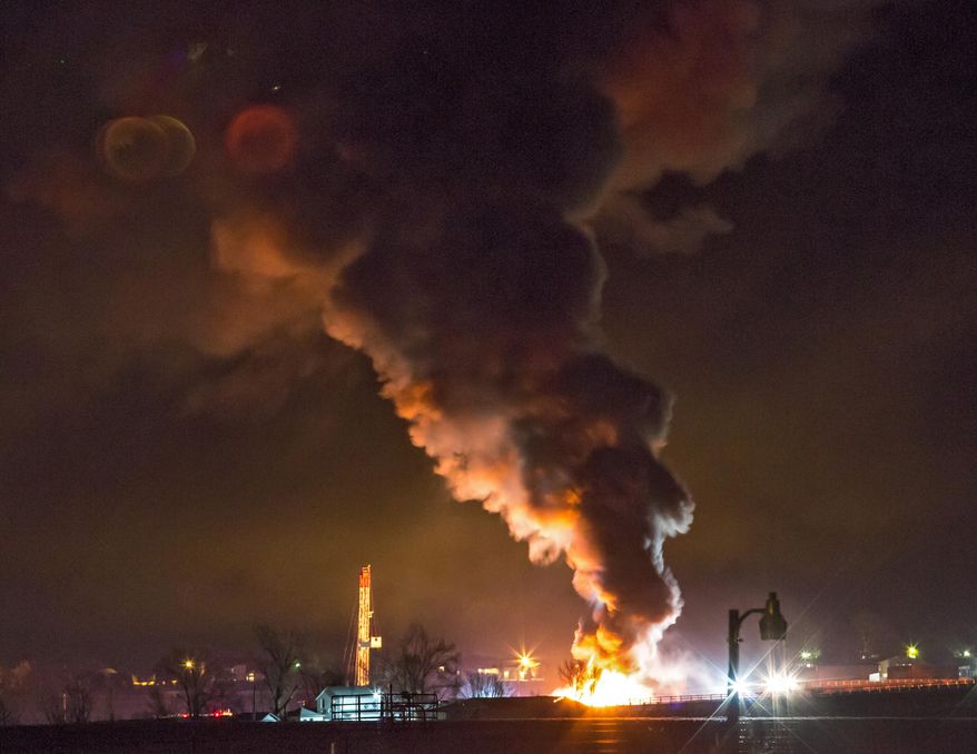 This photo provided by Nathan Hergert shows a fire burning at a oil and gas drilling site near Greeley, Colo., on Tuesday, March 4, 2014. Static electricity is being blamed for the massive explosion and fire at the oil and gas drilling site north of Greeley that injured two workers. (AP Photo/Nathan Hergert) MANDATORY CREDIT; MAGS OUT
