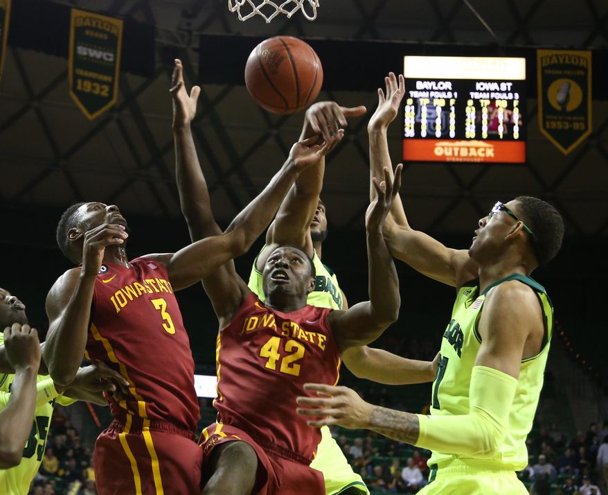 Iowa State's Daniel Edozie (42) and Melvin Ejim (3) reach for a rebound with Baylor center Isaiah Austin, right, during the first half of an NCAA college basketball game, Tuesday, March 4, 2014, in Waco, Texas. (AP Photo/Waco Tribune Herald, Rod Aydelotte)