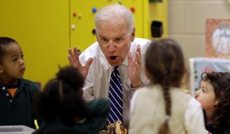 Vice President Joe Biden talks with children in a classroom while visiting the East Lake Family YMCA, Tuesday, March 4, 2014, in Atlanta. Biden is campaigning and raising money around the country for Democrats in the 2014 midterm elections. Many of his stops are in states, like Georgia, where President Barack Obama is unpopular among white voters. (AP Photo/David Goldman)