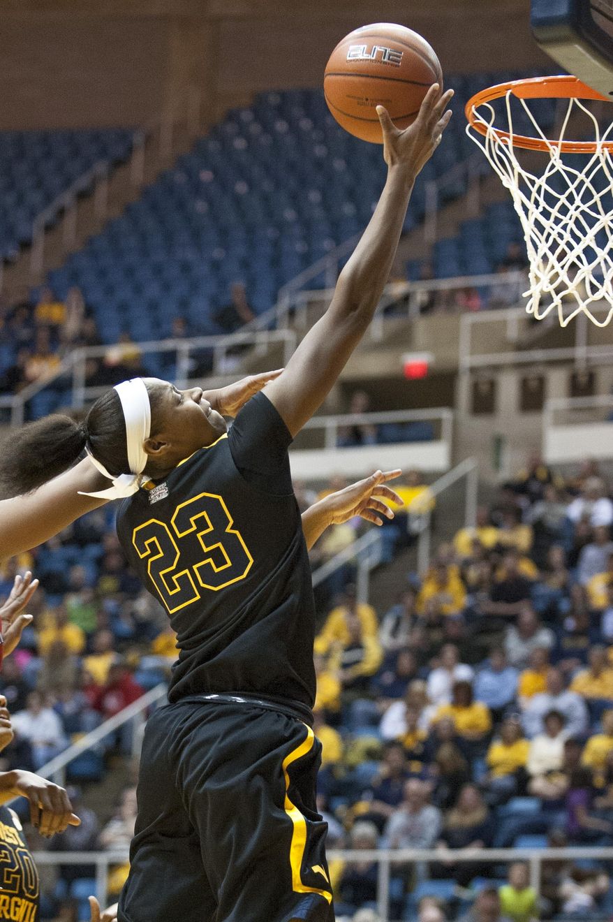 West Virginia's Bria Holmes (23) drives to the basket during the second half of an NCAA college basketball game against Kansas, Tuesday, March 4, 2014, in Morgantown, W.Va. West Virginia won 67-60. (AP Photo/Andrew Ferguson)